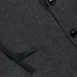 Close-up of the ZEGNA Oasi Cashmere Beaver Jacket, made in Italy in a dark gray cashmere, featuring black buttons, a sharp lapel, and a welt pocket accented with leather trim—an exquisite piece of luxury menswear.