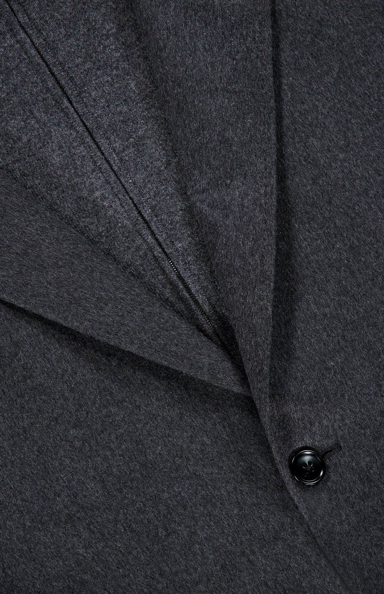 Close-up of the ZEGNA Oasi Cashmere Beaver Jacket in dark gray, featuring a visible lapel, pronounced seam detailing, and a single black button. The luxuriously soft and subtly textured fabric exemplifies the refined elegance of Italian craftsmanship.