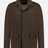 Oasi Cashmere Jacket by ZEGNA: brown wool blend with collar, button-down front, two buttoned flap pockets, long sleeves, and subtle leather accents. Displayed on a plain white background.
