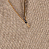 Close-up of the ZEGNA Oasi Cashmere Zip Mockneck Sweater in beige, featuring a textured Italian cashmere knit and a partially unzipped brown zipper. A black brand tag is visible near the collar.