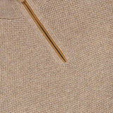 Close-up of the ZEGNA Oasi Cashmere Zip Mockneck Sweater in beige Italian cashmere, featuring a textured knit pattern and a partially unzipped tan zipper at the mock neck collar.