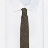 A crisp white dress shirt with a pointed collar is styled with the ZEGNA Geometric Pattern Silk Tie in dark green, shown on a plain white background.