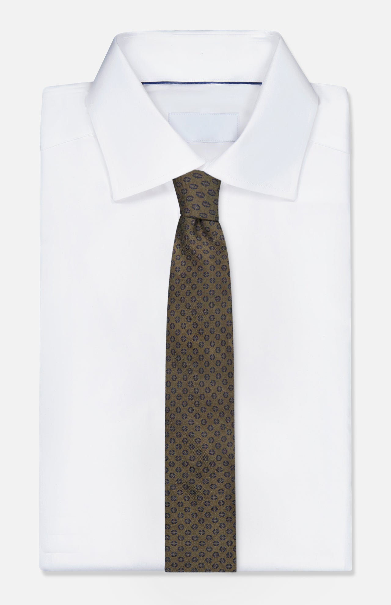 A crisp white dress shirt with a pointed collar is styled with the ZEGNA Geometric Pattern Silk Tie in dark green, shown on a plain white background.