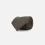 The ZEGNA Geometric Pattern Silk Tie features a dark green rolled-up design with subtle navy blue geometric motifs, crafted from silk and showcased on a plain white background.