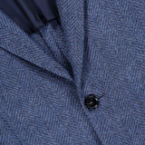 Close-up of the ZEGNA Pure Cashmere Sportcoat in dark blue herringbone with a textured finish, featuring two dark buttons and a glimpse of the navy inner lining.