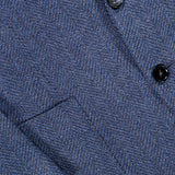 Close-up of the textured blue herringbone fabric of the ZEGNA Pure Cashmere Sportcoat, featuring two black buttons and a pocket detail.