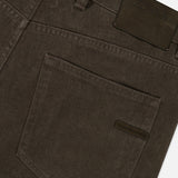 Close-up of the back pocket and waistband of ZEGNA Pure Cotton Slim Fit Pants in dark brown, with a black leather brand patch and belt loops for vintage workwear appeal.