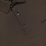 Close-up of a ZEGNA Pure Cotton Short Sleeve Polo Shirt in brown, highlighting the textured fabric, collar, chest pocket detail, two buttons, and brand label inside the neckline. Made in Italy.