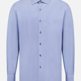 The Pure Silk Dress Shirt by ZEGNA is a long-sleeved, light blue button-up with a classic collar. Displayed front-facing on a white background, it features smooth silk texture and a simple, clean design.