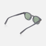 Rounded light blue ZEGNA sunglasses featuring round frames and green tinted lenses, displayed at an angle from the side and slightly above to show the open arms and inner sides of the frame.