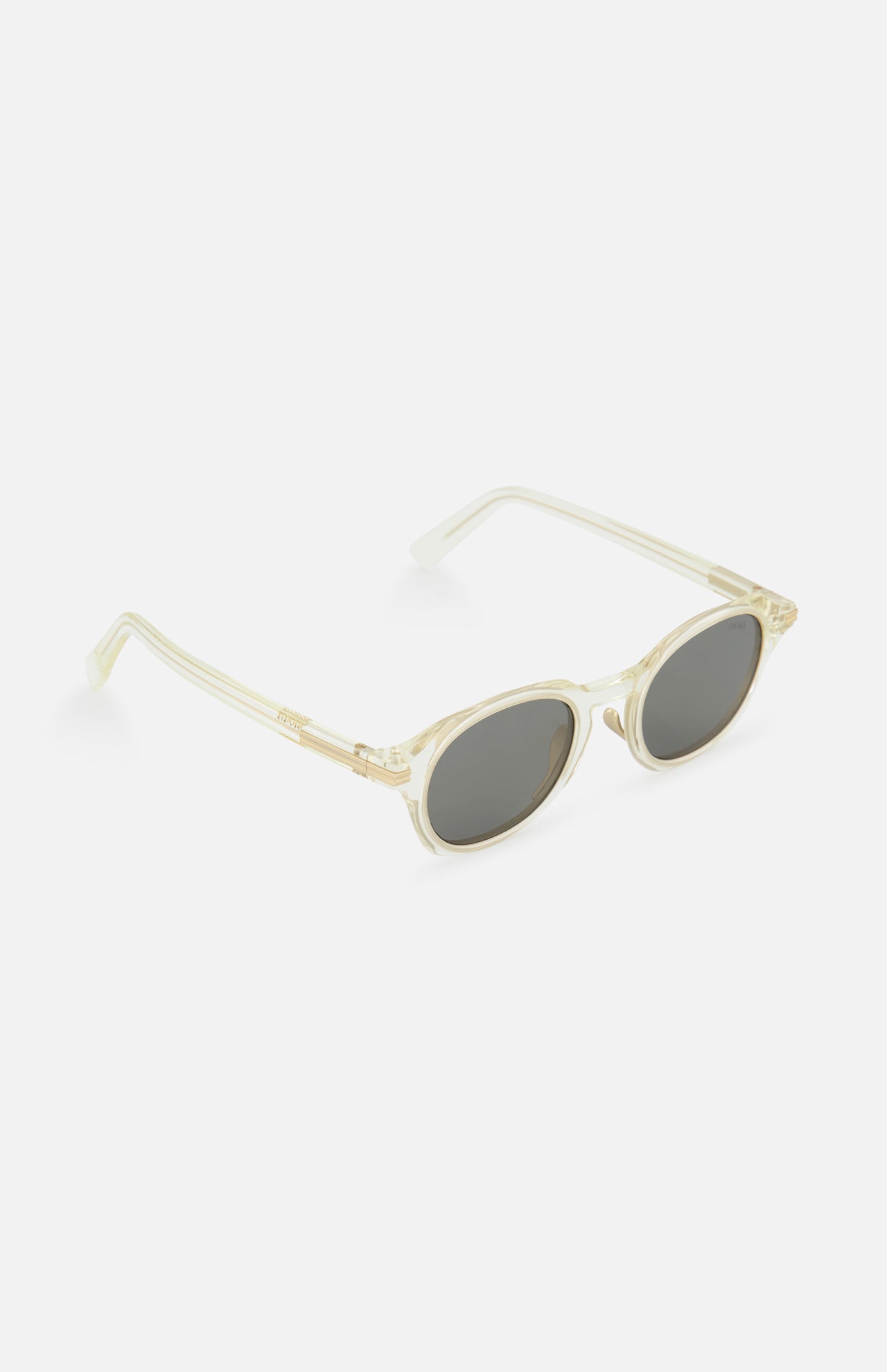 ZEGNA Rounded Champagne Sunglasses feature clear, round transparent frames in light beige and dark smoke lenses, displayed on a white background.