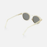 The ZEGNA Rounded Champagne Sunglasses feature a translucent, light beige champagne round frame with smoke lenses and slim transparent arms, shown from a side angle on a white background.