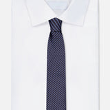 A ZEGNA Silk Jacquard Diagonal Stripes Neck Tie, made in Italy and featuring thin white stripes on navy, is paired with a classic white dress shirt—an elegant men's accessory set against a plain white background.