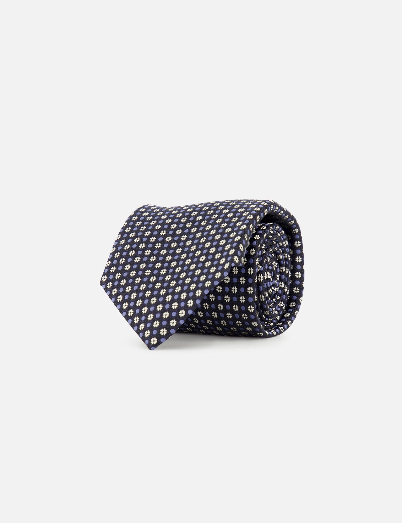 The ZEGNA Silk Jacquard Tie, crafted in Italy from luxurious silk and featuring a small repeating yellow and white geometric pattern on navy blue, is displayed rolled up against a plain white background.