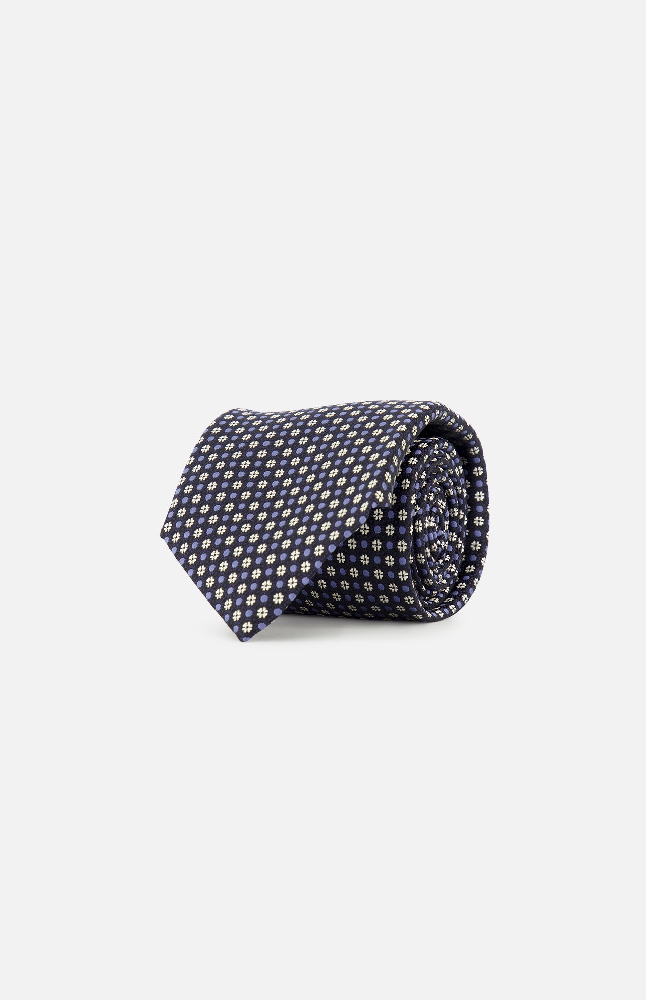 The ZEGNA Silk Jacquard Tie, crafted in Italy from luxurious silk and featuring a small repeating yellow and white geometric pattern on navy blue, is displayed rolled up against a plain white background.