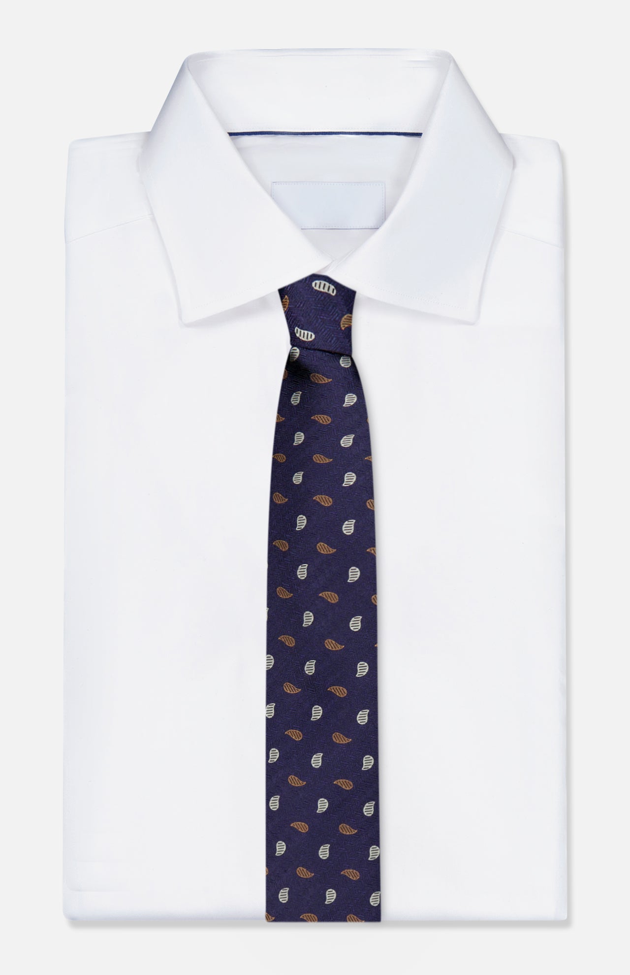A neatly folded white dress shirt is paired with the ZEGNA Silk Jacquard Tie, a luxurious dark blue accessory made in Italy and featuring a small, repeating pattern of brown and light blue leaf shapes.
