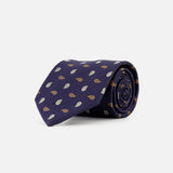 A ZEGNA Silk Jacquard Tie, made in Italy, is rolled up and displayed on a plain white background. The dark blue tie features a repeating pattern of small brown and white leaf-like shapes.