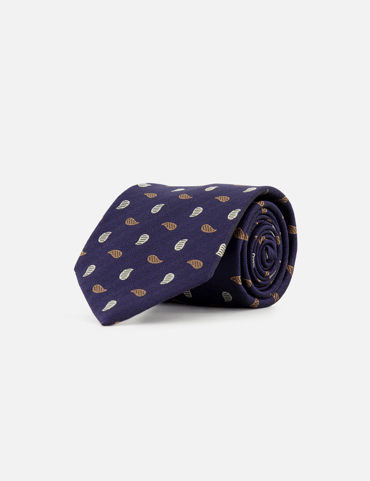 A ZEGNA Silk Jacquard Tie, made in Italy, is rolled up and displayed on a plain white background. The dark blue tie features a repeating pattern of small brown and white leaf-like shapes.