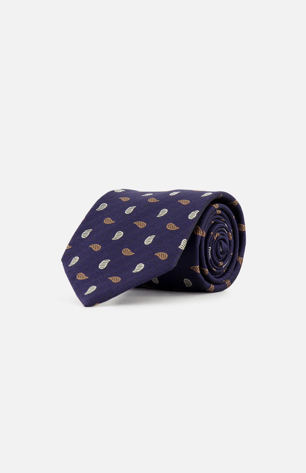 A ZEGNA Silk Jacquard Tie, made in Italy, is rolled up and displayed on a plain white background. The dark blue tie features a repeating pattern of small brown and white leaf-like shapes.