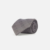 A ZEGNA Silk Jacquard Tie featuring a black and white plaid pattern in grey and black tones, expertly crafted in Italy, is showcased against a plain white background.