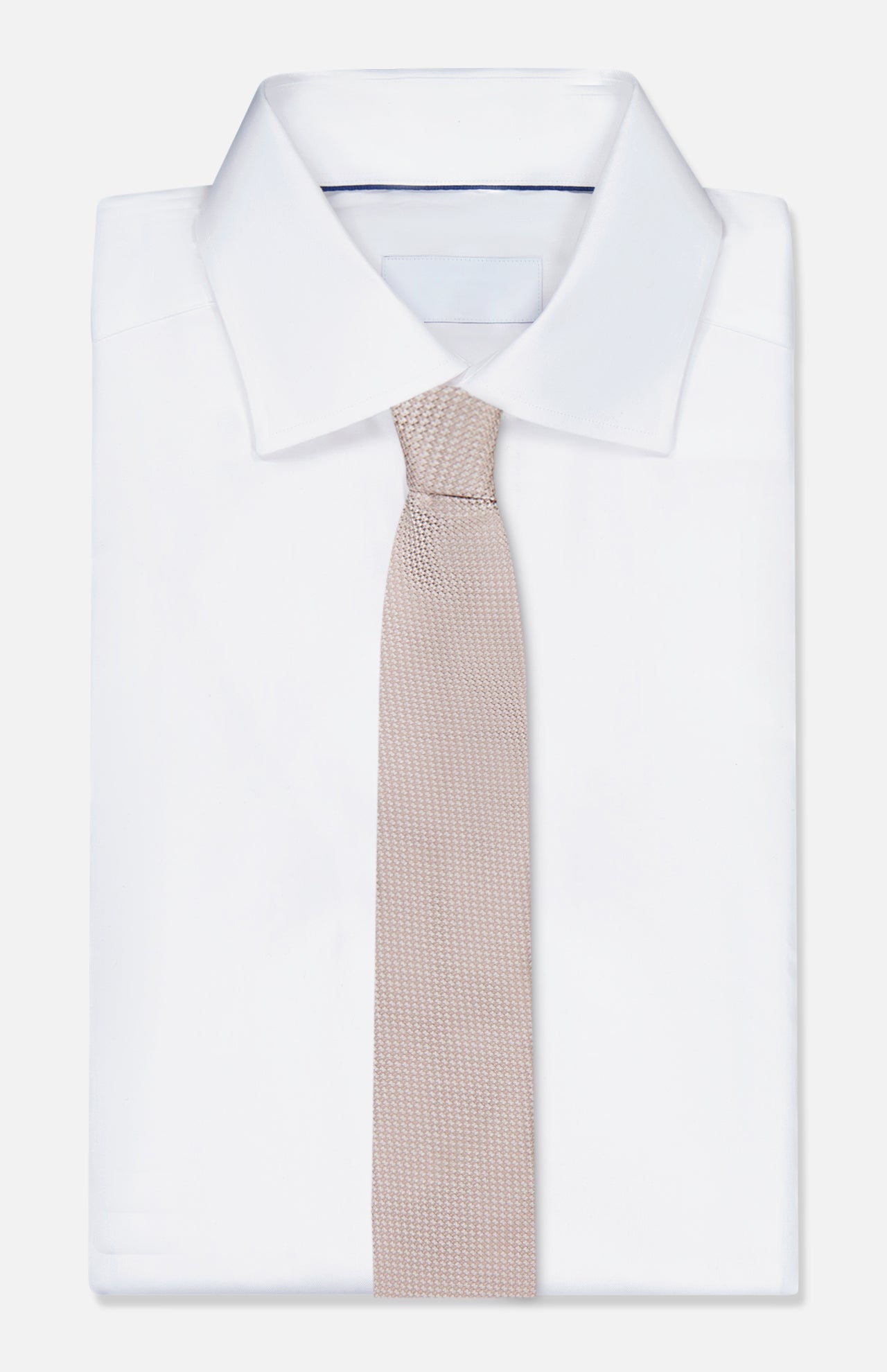 A neatly folded white dress shirt with a pointed collar is paired with the ZEGNA Silk Jacquard Neck Tie, showcased against a plain white background.