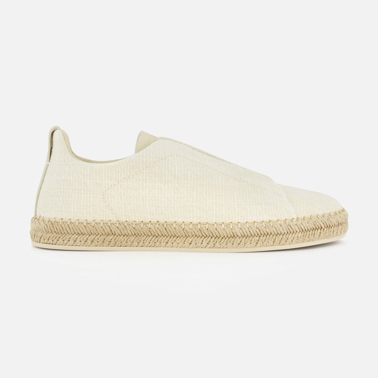 The ZEGNA Triple Stitch Espadrillas Sneakers are minimalist, slip-on shoes in off-white fabric with a rounded toe and natural jute-wrapped sole, shown on a plain white background.