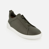 Olive green suede ZEGNA Triple Stitch Low Top Sneaker with a white rubber sole and signature elastic crossover detail on the tongue.