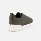 Rear three-quarter view of a ZEGNA Triple Stitch Low Top Sneaker in olive green suede with a thick white rubber sole.