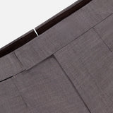 Close-up of the waistband and upper section of ZEGNA Trofeo Wool Adjustable Tab Pants in gray, featuring belt loops, detailed stitching, and pocket seams against a white background.