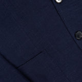 Close-up of the ZEGNA Trofeo Seersucker Suit Jacket in navy, featuring textured fabric, two dark buttons, a front pocket, and part of the lapel—an essential piece for any men's professional wardrobe.