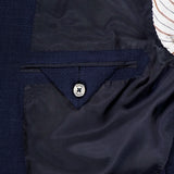 Close-up of the ZEGNA Trofeo Seersucker Suit Jacket’s interior, featuring a buttoned pocket with dark stitching and partially visible striped lining at the top right.