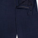 The ZEGNA Trofeo Seersucker Suit Trouser Pant in navy blue showcases textured fabric, partially unzipped and unbuttoned to reveal the waistband, inner lining, closure details, and adjustable side tabs.