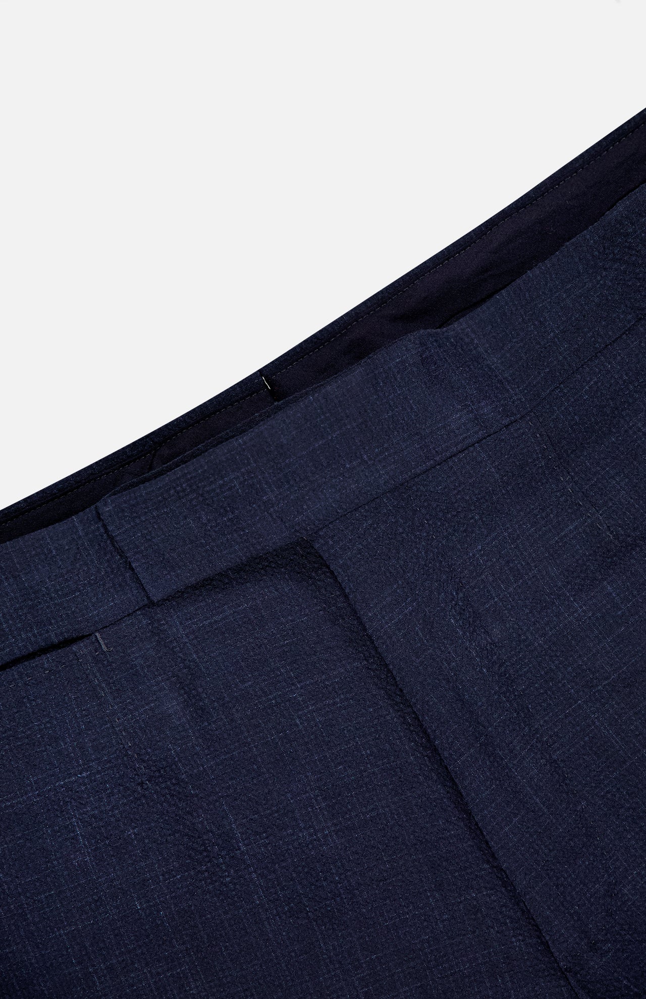 Close-up of the waistband and upper section of ZEGNA’s Trofeo Seersucker Suit Trouser Pant, showcasing the textured navy fabric, adjustable side tabs, and a partially visible seam.