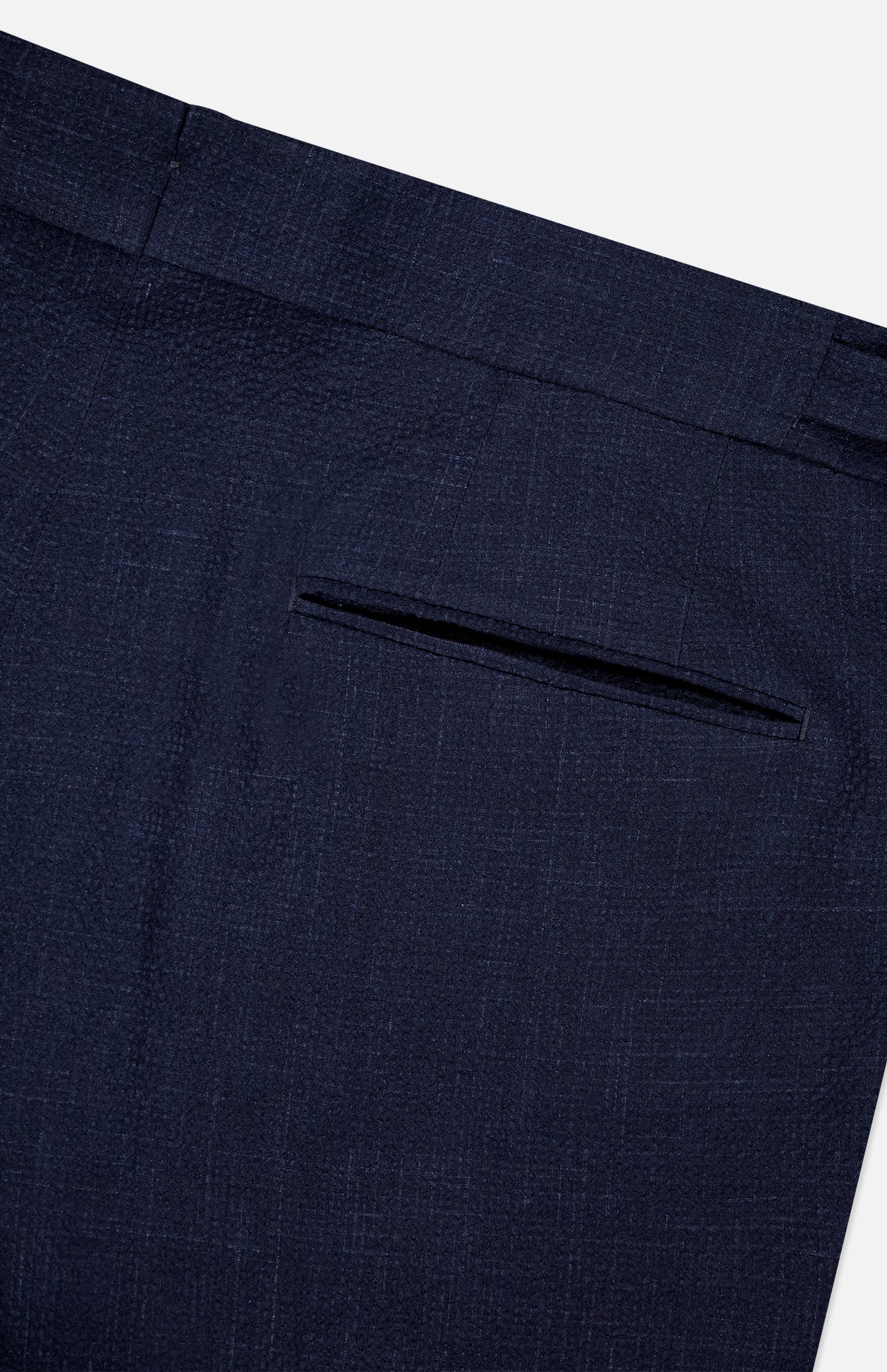 Close-up of the ZEGNA Trofeo Seersucker Suit Trouser Pant in dark blue, showing the back pocket area with a single welt pocket and part of the waistband against a white background.