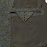 Interior detail of a textured olive and blue ZEGNA Wool & Cashmere Sportcoat, showing a triangular-flapped chest pocket over a dark brown lining.