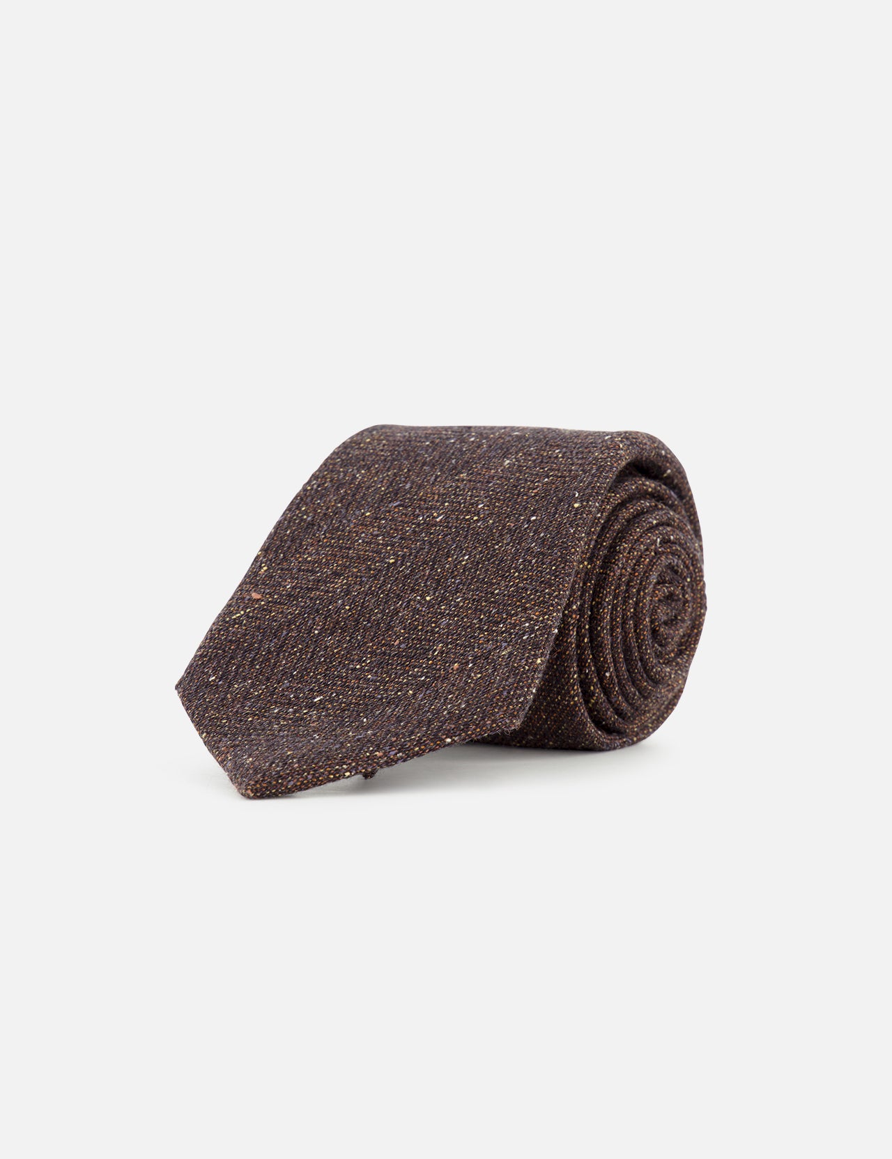 A ZEGNA Wool & Silk Jacquard Tie in dark brown is rolled up and displayed on a plain white background. Expertly crafted in Italy, this textured necktie exudes timeless elegance.
