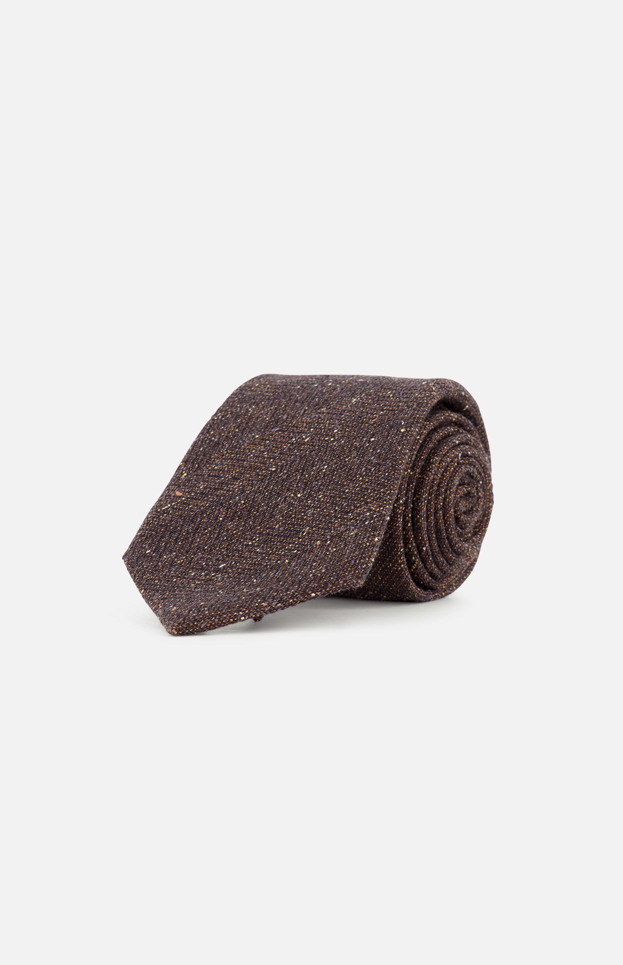A ZEGNA Wool & Silk Jacquard Tie in dark brown is rolled up and displayed on a plain white background. Expertly crafted in Italy, this textured necktie exudes timeless elegance.