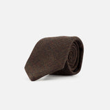 A ZEGNA Wool Jacquard Tie, crafted in Italy from pure wool, features a brown textured design and is shown rolled up against a plain white background.