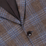 Close-up of the ZEGNA Wool Silk Linen Sportcoat, featuring a brown and blue plaid pattern, crafted from a luxurious blend of wool, silk, and linen. The image highlights two dark buttons, a visible lapel, and part of the dark inner lining.