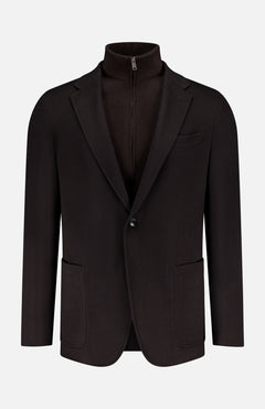 The ZEGNA Oasi Cashmere Blazer Jacket, in dark brown with two patch pockets, a notched lapel, and single-button closure, is styled over a high-collared zip-up sweater—modern quiet luxury set against a plain white background.