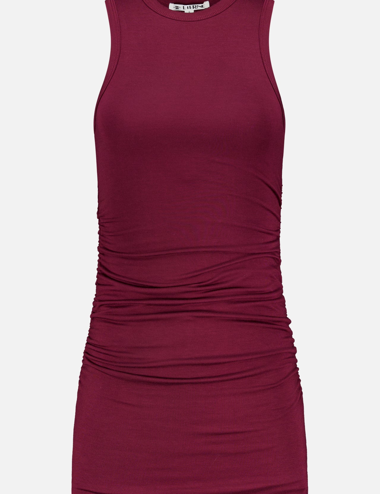 The ETERNE Carrie Ruched Mini Dress is a sleeveless, fitted burgundy jersey modal-blend design featuring a crew neckline and gathered ruching at the sides and midsection, shown here on a plain white background.