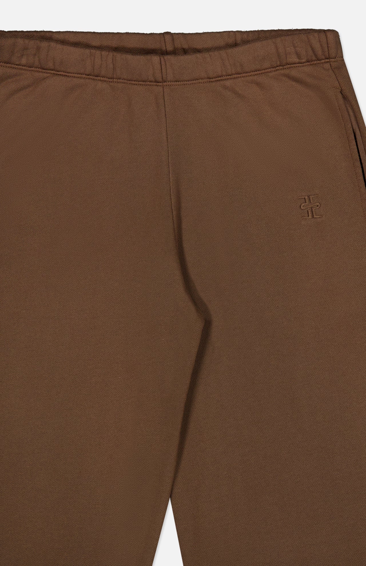 Close-up of ETERNE’s Oversized Wide Leg Sweatpant in brown, featuring an elastic waistband, side pocket, and a small stitched logo on the left. The soft French Terry material and wide-leg design offer a comfortable feel and relaxed fit.