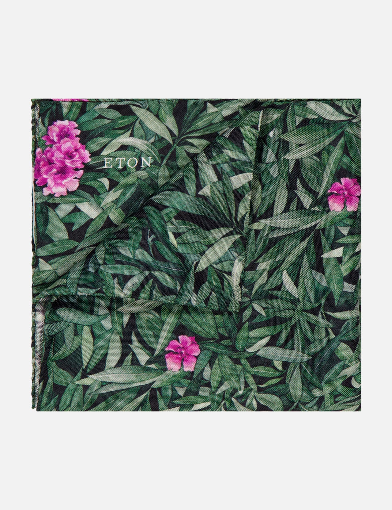 The ETON Floral Silk Pocket Square is a green silk men's accessory featuring a leafy pattern with pink flowers and the brand name in white—an elegant, tropical touch to complete your refined look.