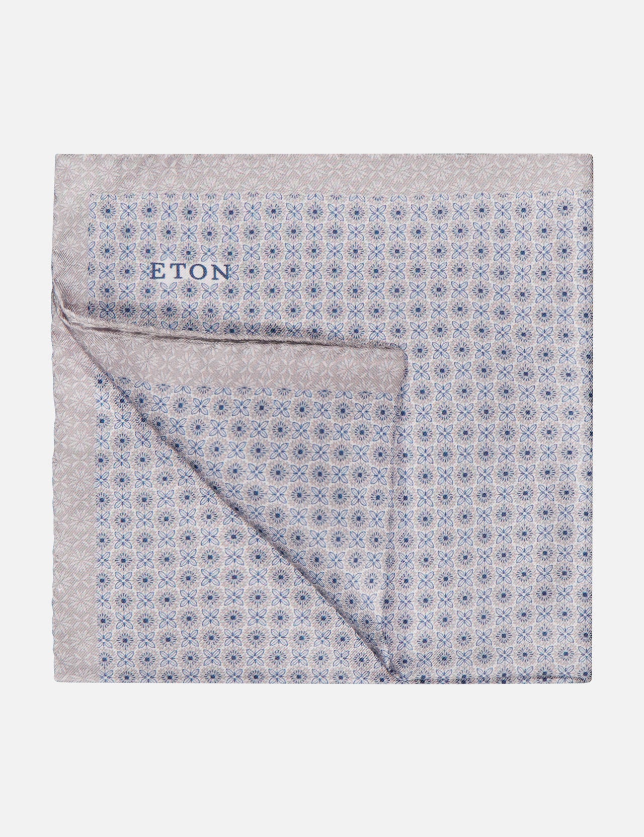 A folded Geometric Silk Pocket Square by ETON in light-colored silk with an intricate blue and gray geometric pattern and ETON branding, made in Italy.