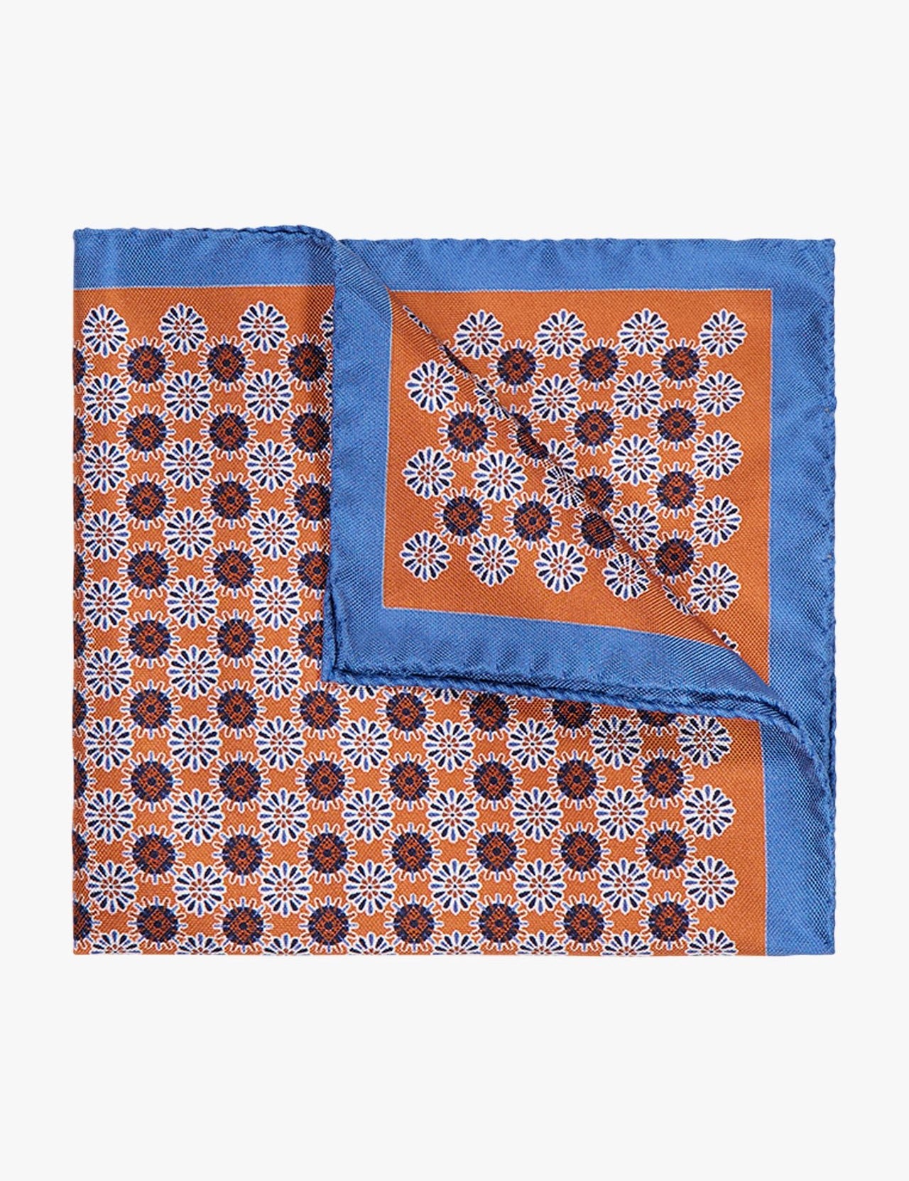 The ETON Geometric Silk Pocket Square, made in Italy, showcases a blue border, orange center, and white and dark brown geometric motif. A folded corner highlights its luxurious silk reverse.