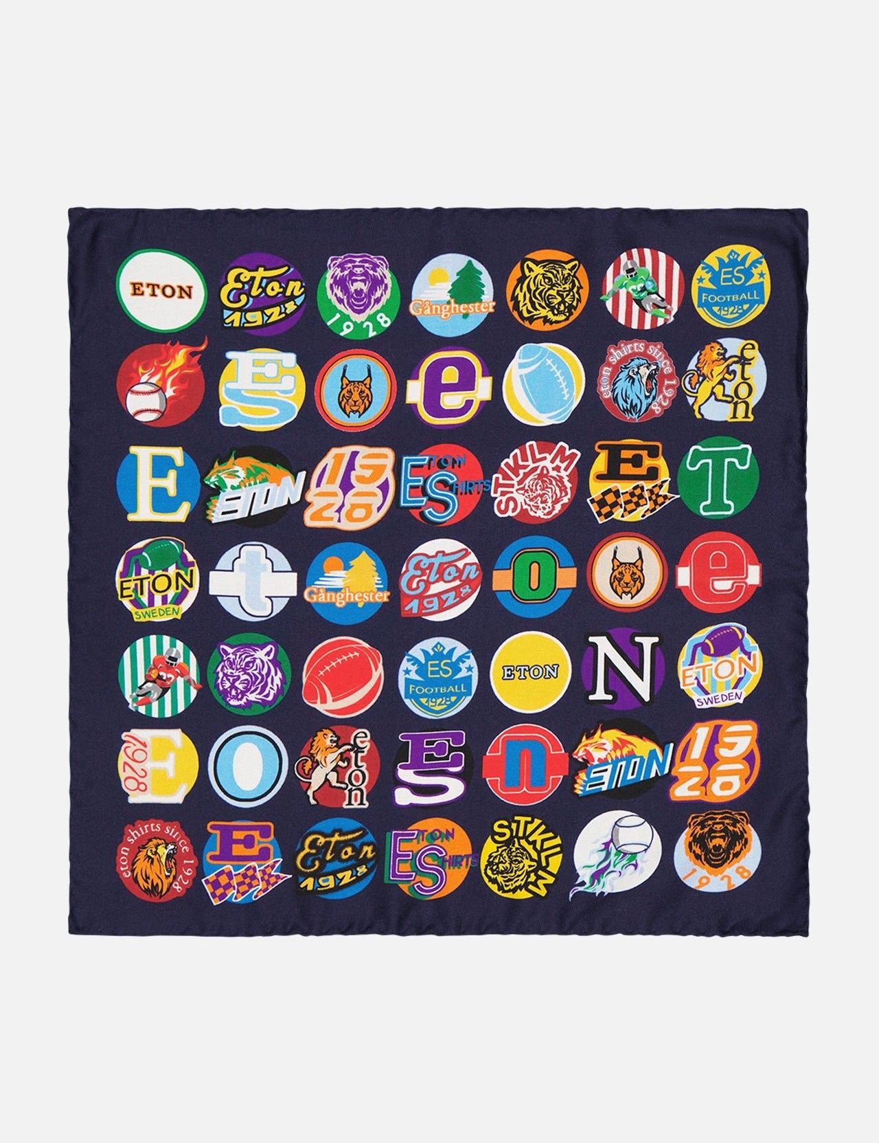 The ETON Ivy League Sports Pocket Square is a navy blue silk accessory decorated with colorful badge-style logos, including tigers, lions, letters, and images inspired by classic Ivy League motifs.