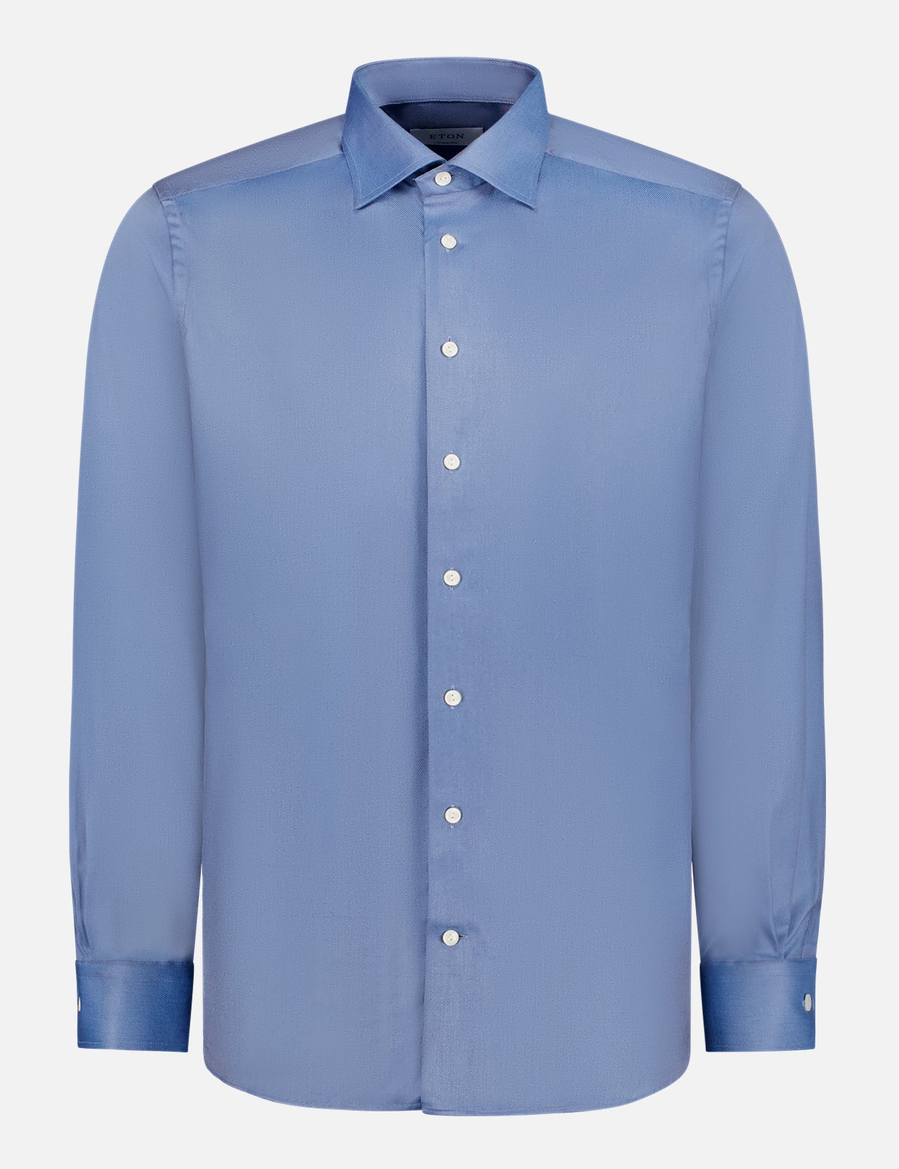 The ETON Melange Solid Cotton Tencel Lyocell Shirt is a slim-fit blue dress shirt with long sleeves, a pointed collar, and white buttons, made from crease-resistant fabric and shown on a plain white background.