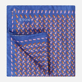 The ETON Ananas Silk Twill Pocket Square is blue with a repeating orange and pink pineapple pattern; one corner is folded to display the reverse side.