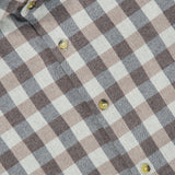 Close-up of ETON’s Block Check Flannel Shirt in brown and white, featuring a pure cotton fabric that accentuates the classic checkered pattern. Yellow buttons provide a distinctive touch, and the collar along with a portion of the ETON label can be seen at the top left of the image.