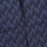 A folded piece of fabric with a repeating chevron pattern in various shades of dark blue, the ETON Chevron Silk Twill Pocket Square features a subtle texture and visible creases along the center, making it an ideal luxury men's accessory. This silk twill pocket square adds a refined touch to any ensemble.